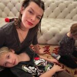 Milla Jovovich Instagram – Happy New Year from the Andersons! This post goes back in time of our epic New Year’s Day. It starts with a hard won family photo where almost everyone is in focus.  Before that I made dinner in our hotel using a one burner hot plate (half the food was pretty lukewarm but still delicious). I made my mom’s famous fried potatoes which is always a hit with the kids, but also some gorgeous asparagus and trumpet mushrooms fresh from the farmers market here in Krakow. I even have my super Eastern European wire rack where I keep the veggies☺️. And of course this morning started with an epic New Years trip to the laundromat which though not very glamorous, was extremely necessary😂. I’m sending so much love to everyone and I hope this New Year brings us all health, love and patience for ourselves and others. Ok, it’s time to put the baby down. Have an amazing night everyone!🍾🎆🎊🎉🎈xo m❤️
