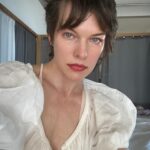 Milla Jovovich Instagram – Good morning! I’ve had a chance to spend some time on my own to catch up on work and just have some me time! Summer is no joke with kids out of school and it’s been busy in the Jovovich-Anderson household with 3 kids and 3 dogs! Apart from catching up on some great tv shows, I’ve been adapting a book into a screenplay (it’s not sci fi either hehe), which has been a very interesting experience. I’ve always loved writing and this has actually made me love and understand this book so much more because suddenly the characters have taken a life of their own in my imagination. Different from just reading it because I’m actually able to allow them to speak their thoughts out loud, if that makes sense. I’ve also been doing some more artwork on my walls. Some of you commented on the art behind me in my last post and I decided to mess around with it some more because I wasn’t happy with it when I drew it and kind of left it for a while. (Swipe to the end to see what it’s turned into.) I think it’s pretty cool so far, but my wall art is always developing and changing which is a lot of fun. Every morning I exercise my dogs, but especially my huge, dragon dog Welly. I call him my personal dragon because he’s enormous, super protective and when he jumps to catch the ball, he looks like he should sprout wings. I also got some rad pictures of some beautiful flowers that just came up in our backyard. I’m not sure what species they are, but they’re drought resistant because they’ve managed to survive here as innocuous bushes even without water for ages before the rain came and then suddenly flowered into these brightly colored beauties. I got a picture of a bee on one of them (towards the end of the series) and on another I zoomed in and realized that a fly landed on the same flower as the bee! Kind of strange but I think it’s a great moment. Anyway, enjoy my photo dump of the last 12 hours! Have a great day everyone!💥