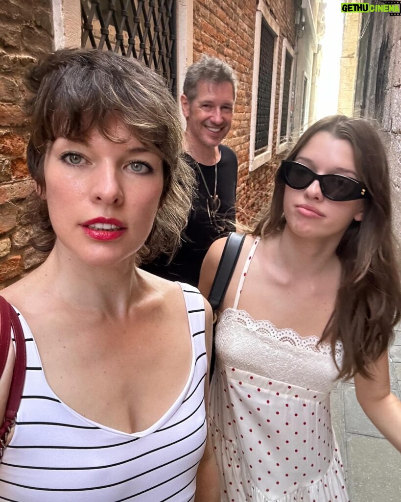 Milla Jovovich Instagram - I’m so excited to have been invited to attend the @amfar event and help raise money for this cherished cause in Venice, Italy! It’s been a healthy decade I haven’t been to Venice and it’s such a dream coming back here. Riding from the airport in a water taxi, watching the delicate, medieval city, opening up before me in such a calming and soothing way after a long and sleepless flight. The feel of the boat rocking underneath me is already getting me prepared for delights to come. We float on the water and get dropped at our hotel, which is a thousand year old monastery that was actually abandoned for over one hundred years before it got renovated into a hotel.  A bit on the spooky side, but I’m totally in to see some ghosts, hands down!  The light is so gorgeous everywhere that even with no sleep on the flight (I started playing Baldur’s Gate 3🤯 and I wasn’t about to have something as pesky as sleep stop me from jumping down that rabbit hole😂 ) I just put on minimal make up, tinted sunscreen, mascara, spf lipstick, I feel red carpet ready! This light ignores signs of jet lag and literally gives you a wink and secretly hands you 5 years back without even asking for a thank you. We’re only here for a few days, @everanderson is here working with the wonderful team @miumiu, doing her thing  and we brought our little Dash with us so we could make her feel grown up and special. It’s hard to give all three of my girls proper mama time when our 3 year old , Osian, is around. She’s just a mighty force of nature that demands absolute and undivided attention and the more you give, you know it’s only enough when your essence has completely disappeared into her own. She’s a smart kid😂. Goes without saying that we’re having a blast! I’ll go through more photos and do a nice dump when I get home! Thank you @amfar again for believing in me and having me here to support you for so many amazing years and thank you @miumiu for always taking care of my incredible young woman, my heart, Ever. ❤️🧨💥✨✨✨