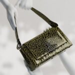 Vivienne Westwood Instagram - Introducing our medium Hazel bag, featuring this season's 'Sticky Croc' design, complete with an imaginary prehistoric reptile motif. The piece is finished with patent embossing, as a playful ode to 80's style.⁠
⁠
Coming soon.⁠
⁠
⁠
#VWSS24