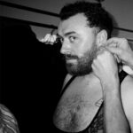 Vivienne Westwood Instagram - BEHIND THE SCENES: Echoing the ‘Blackout’ theme, @samsmith ‘s bespoke Vivienne Westwood show looks are presented in shades and textures of black.⁠
⁠
For the opening look, Sam appears in a double-breasted cropped jacket with braided epaulettes and aiguillettes worn with sailor trousers.⁠
⁠
Later in the show Sam reveals a corseted bodice paired with our iconic SEX choker and spiral lace gloves with claws.