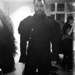 Vivienne Westwood Instagram - BEHIND THE SCENES: Echoing the ‘Blackout’ theme, @samsmith ‘s bespoke Vivienne Westwood show looks are presented in shades and textures of black.⁠
⁠
For the opening look, Sam appears in a double-breasted cropped jacket with braided epaulettes and aiguillettes worn with sailor trousers.⁠
⁠
Later in the show Sam reveals a corseted bodice paired with our iconic SEX choker and spiral lace gloves with claws.
