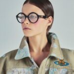 Vivienne Westwood Instagram - Our oversized Cropped Denim Boxer jacket features this season's floral jacquard, inspired by an archival corset from our Spring-Summer 1998 'Tied To The Mast' collection. ⁠
⁠
Style the piece with our Tyra Toy Box bag, featuring a bone motif that links together with rivets, forming the words 'Puppy Love'. The style is reminiscent of our Rock chicken bone T-shirt, from the archive 'Let It Rock' collection of 1971.⁠
⁠
Now available online and across our boutiques.⁠
⁠
#VWSS24