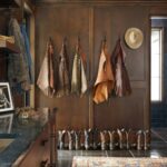 Ree Drummond Instagram - Here’s Ladd’s mud room and here’s what’s in it: coats, jackets, boots, spurs, work gloves, hats, Carmex, tools, sink, ice maker (for coolers), pop fridge (for Dr Pepper), bathroom (I don’t go in there), washer/dryer (never had separate ones before now and I embrace it), and an old pic of him and his brothers in their old barn. Oh, and mud. (And he still looks good in chaps, btw…)