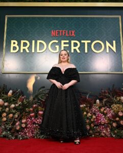 Nicola Coughlan Instagram - Surprise Oz! Lady Whistledownunder is in town 

So excited to kick off the Bridgerton World Tour in Australia! This moment has been literal years in the making I’m so excited we can finally start to share Season 3 with you all ❤️

A special thank you to THE Richard Quinn- I contacted him because I have been obsessed with this dress since I first saw it on the runway and dreamed of wearing it. I asked him if he and his brilliant team made it for me and they they did and it’s better than I ever could’ve imagined 🖤

Styled by @aimeecroysdill wearing custom @richardquinn & @malonesouliers 
Makeup @danielmartin 
Hair @gavinanesburybeauty 
@vrwpublicity 

#bridgerton #bridgertoninbowral