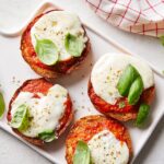 Martha Stewart Instagram - Why should bagels get to have all the fun? Each toasted English muffin is topped with marinara sauce and melty cheese before being garnished with a pinch of dried oregano and a few leaves of fresh basil. Play around with the flavors to create the pizza snack of your dreams. Get the recipe for these nostalgic treats at the link in our bio. 📷: @jason_donnelly_photography