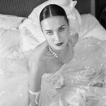 Vivienne Westwood Instagram - The Eline gown offers an unwavering sense of romanticism, embroidered with a Flora motif, taken from an archival couture lace. ⁠
⁠
The dress features a voluminous skirt with panniers, along with a straight neckline and transparent boned low hip corset bodice, accentuating the waistline. ⁠
⁠
The look is styled with fingerless gloves, echoing the decorative  detail of the dress. ⁠
⁠
Photography by @kingsley_ifill⁠
Styling by @florahuddart⁠
Talent: @elinehoyois⁠
⁠
#VWBridal #WestwoodBridal