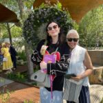 Aisling Bea Instagram - Avoided drawing attention to myself today @the_rhs Chelsea Flower show, if you zoom in, you will be able to make me out. I LOVE power plants & BIG bushes & there were so many on display today. But my favourite garden was my friend @tommasseyuk ‘s one for @wateraid which he co-designed with Je @studioweave - both seen here with @josh_widdicombe who did not get the “dress like a flower”memo. The garden features flowers and plants which are resilient to extremes in weather, especially rainfall, which is more important than ever with our changing climate. Also some flowers which may be not deemed as fancy and pretty as others, which breaks my hear as they are ALL loveable. Almost one in ten people around the world don’t have access to clean water close to home, and the climate crisis is making it worse. So the mushroom like design is a rainwater-harvesting pavilion inspired by WaterAid’s work in communities around the world. “But tell us about your outfit so we too can completely cover up in the sun!” Well, I tried to wear an eco outfit today featuring a gorgeous but ill advised in the sun jumper from small brand @theslowlove , a flowery dress from @reformation who make their clothes from leftover material, jewellery & a handbag which fits everything from a variety of charity shops & some earth day shoes from eco brand @vivaia_official who make their shoes from recycled materials and try to reduce waste in their factories. Bought everything so you can TRUST ME. Thanks to @thenewtinsomerset & @the_ivy_collection for feeding myself, my brother in law @mkidao & auntie in law - we are stuffed and covered in pollen. And thank you to @lordham for making sure my hair was nice and shiny. xxx