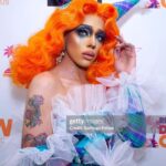 Aja Instagram – People are always talking about how they want this Aja to come back. But the truth is in this era of my life I was not being authentic to myself, and I kept formfitting myself to be something I wasn’t because I felt so unloved for being who I was I created this character that I knew to world with love, and it was, the true pinnacle of my artistry. Taking things that I saw people loved and styling it to myself. Now that I am fully realizing who I really am though. I know that it would be a different story.

I look back and see the way that this turned into the infamous “burlesque rapper” era and I cringe, because I don’t think that that was some thing that I really wanted either. I think all I really wanted was to be seen as a woman and not a person who is performing the caricatures of a woman. But I was in such denial. I often feel that this era of my artistry ruined a lot of my career and pushed away thousands and maybe even hundreds of thousands of fans I’ve watched slowly over the past few years as I ago from almost hitting 1, million followers on Instagram to pinching back down and the constant commentary about “ didn’t she quit?” And such. My one confession today is that I really wish I would have had the resources to overcome my gender, dysphoria and privacy, and not made my struggles so public. I often wonder how differently it would affect my career today. Nonetheless, I am very proud of the woman I have become and I hope one day those hundreds of thousands of fans that I have lost can look back and learn to love me again. Because as it stands, I feel like compared to before it is much more a few people who are supporting my artistry at the moment, and it has led to a lot of me doubting the future of my artistry but with that I say, I will stay and stand strong. I know that I have not hit my peak yet as I get ready to load my next era, I said buckle up kids. This one is for you. 💛✨🩸