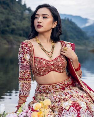 Alisha Rai Instagram - Swornim Studio’s “Kamal Shrinkhala” in Red: The Epitome of Elegance🌹

@alisha_rai_official_  has truly elevated the allure of the Red Edition of Kamal Shrinkhala in a mesmerizing manner, making it the perfect choice for weddings.

Jewelry Collab: @shagoonjewellers 
Team:
Photography: @rijan_satyal 
Videography: @czan_ 
Photography assistant: @mahendra_baniya_12 
Main Assistants: @aarav_singh1 @rabin_pry 
Muses/Models: @alisha_rai_official_ Stylist: @marcos_blenden 
Makeup Artist: @sangu_lamtari 
Hair Artist: @hairartist.durga 

#SwornimStudio #KamalSrinkhala #WeddingCollection #LuxuryBridalWearBySwornimStudio #LuxuryNepaliBridalWear #Swornim #Kamal #WeddingLehenga #NepaliDesigner #NepaliWeddingdesigner #WeddingLehengaInspiration #Nepaliwedding #NepaliWeddingDiaries