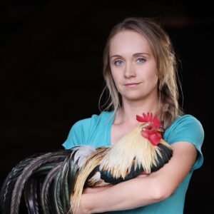 Amber Marshall Instagram - This week I decided to go with my main man of the chicken coop for my #MarshallSundayStory please put your hands together for, Phoenix the rooster. 

Phoenix is not just any ordinary rooster. Not only has he travelled across the country to star in a commercial, but he also has spent far more time living inside our home than your average farmyard bird. Phoenix was one of many chicks that I purchased in the spring of 2019. Being smaller in size, he was instantly targeted by the flock and picked on. One day, I went out to find him badly beaten by the other members of the coop. I scooped him up and decided that he needed to come spend some time in the house recovering. He became so comfortable in the house and friendly with us, he stayed far past his welcome. Over the next couple years Shawn and I moved and started building at our new property. We didn’t have a barn or a chicken coop so again, Phoenix (who at the time was the only bird we had) made himself at home, living in our little cabin. He would wander around the yard during the day, and in the nice summer months would sleep on our front porch. 

When winter came I set up an area for him in the cabin… but for those who have been around roosters, know that their early morning crowing can be deafening. We soon put a stop to this as our cabin is only one room and it echoed quite loudly each morning. 

By this time our barn was nearly finished anyway so I moved him to his own spot out there and purchased 4 Americana (a breed of laying hen) chicks to keep him company. 

Phoenix has been around for five years now and is definitely the king of his castle now. His 4 ladies are still doing well and we have since built them a coop of their own. This rooster has been more than just a bird to us and I thank him for being such a special member of our family. 

#AmbersRoosterPhoenix To view more Animal Stories click #MarshallSundayStory