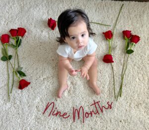 Anjelah Johnson-Reyes Instagram - My sweet angel baby. We can’t believe you’re 9 months old already! You’ve been on 13 flights. You are currently sleep training (again). You recognize your different family members on FaceTime by the things they do and say. You love your doggie brother Banzo. You gnaw on a chicken bone like a grown man and we love it! Happy 9 months #Rosieharlowreyes