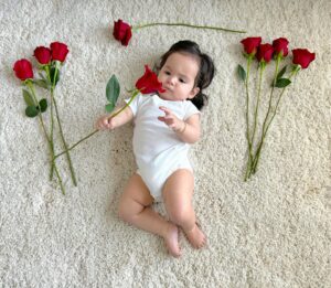 Anjelah Johnson-Reyes Instagram - My sweet angel baby. We can’t believe you’re 9 months old already! You’ve been on 13 flights. You are currently sleep training (again). You recognize your different family members on FaceTime by the things they do and say. You love your doggie brother Banzo. You gnaw on a chicken bone like a grown man and we love it! Happy 9 months #Rosieharlowreyes