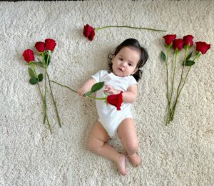 Anjelah Johnson-Reyes Instagram - My sweet angel baby. We can’t believe you’re 9 months old already! You’ve been on 13 flights. You are currently sleep training (again). You recognize your different family members on FaceTime by the things they do and say. You love your doggie brother Banzo. You gnaw on a chicken bone like a grown man and we love it! Happy 9 months #Rosieharlowreyes