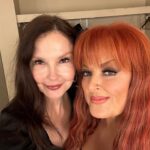 Ashley Judd Instagram - My big sister. My protector who powdered me when I was an infant, let me do her Civics homework when I was in 6th grade (which made me feel "big”), who taught me how to drive (it was a 1957 Chevy), with whom I compared mosquito bites after we played in eastern Kentucky creeks looking for crawdads. Oh, yes — she happened to sing some, too. This past Friday, she sang in Knoxville, and it was glorious. My favorite songs are the ones our Mama wrote, so customized for her voice are they. Thank you to fans for loving my sister @wynonnajudd and helping to give her life purpose and meaning, and for recognizing that she’s indeed the G.O.A.T.