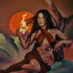 Bella Hadid Instagram - Wrapped in the sun’s golden embrace 🔥 Explore BLOOMING FIRE: a transportive warm floral featuring monoi, bergamot & patchouli. Shake to activate and escape to the desert. Available NOW at Orebella.com