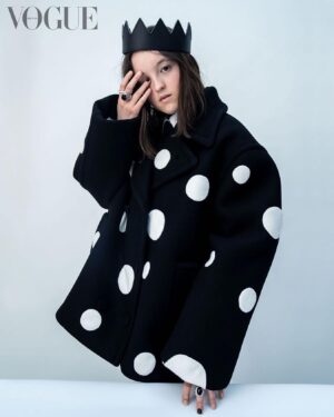 Bella Ramsey Instagram - Posted @withregram • @britishvogue “‘They’ pronouns are the most truthful for me,” @BellaRamsey shares in #BritishVogue’s July 2023 issue. Having first appeared in #GameOfThrones aged just 11, the now 19-year-old actor became Hollywood’s most in-demand young star overnight when they landed the role of Ellie in ‘The Last of Us’ – and credits both #PedroPascal and their “gay army” with supporting them through the intense press scrutiny that followed. Click the link in bio to read the profile in full, and find the Pride portfolio in the new issue, on newsstands Tuesday 20 June.

#BellaRamsey wears a coat, shirt and tie by @MaisonValentino, crown by @Mr_Riegillio, silver ring by @ShaunLeaneJewellery and silver and onyx ring by @TheGreatFrogLDN, photographed by #TimWalker and styled by @KPhelan123, with hair by @AliPirzadeh, make-up by @BeaSweetBeauty, nails by @Simmy_NailsAndBeauty and production by @Zoe_Wassall at @GreatSouthernProductions.

[Image Description: Image shows Bella Ramsey, a white non-binary actor with straight brown hair, standing against a grey backdrop. They are wearing an oversized black blazer with big white spots, and a black crown. Their left hand rests gently on a surface in front of them, and their right arm is lifted, with their fingers covering their right eye.]