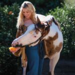 Beth Behrs Instagram - “Horses imprint themselves in your soul. There’s a spiritual majesty to them that is like no other animal. They are magical, mystical, and mysterious, and I think that’s what draws them to us for life.” Click the #linkinbio to read @bethbehrs’ cover story on the COWGIRL App✨ Photographed exclusively for COWGIRL by @abbylinne #BethBehrsCOWGIRL #iamcowgirl #cowgirl #cowgirlmagazine #western #westernlifestyle #westernfashion #horse #horses #ranchlifestyle #rodeo #ranch