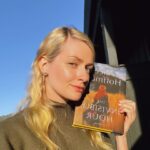 Beth Behrs Instagram - Inspired by my girl @emilyhenrywrites and her #book #selfies. I am madly in love with this one @ahoffmanwriter ! I love all of your books and read them always at the beginning of Fall! 🍂🍁🍂🌾 #bookstagram #books #booklover #booknerd #bookaddict #bookworm #fall #falldecor #practicalmagic #witch #witchesofinstagram #booktok #read