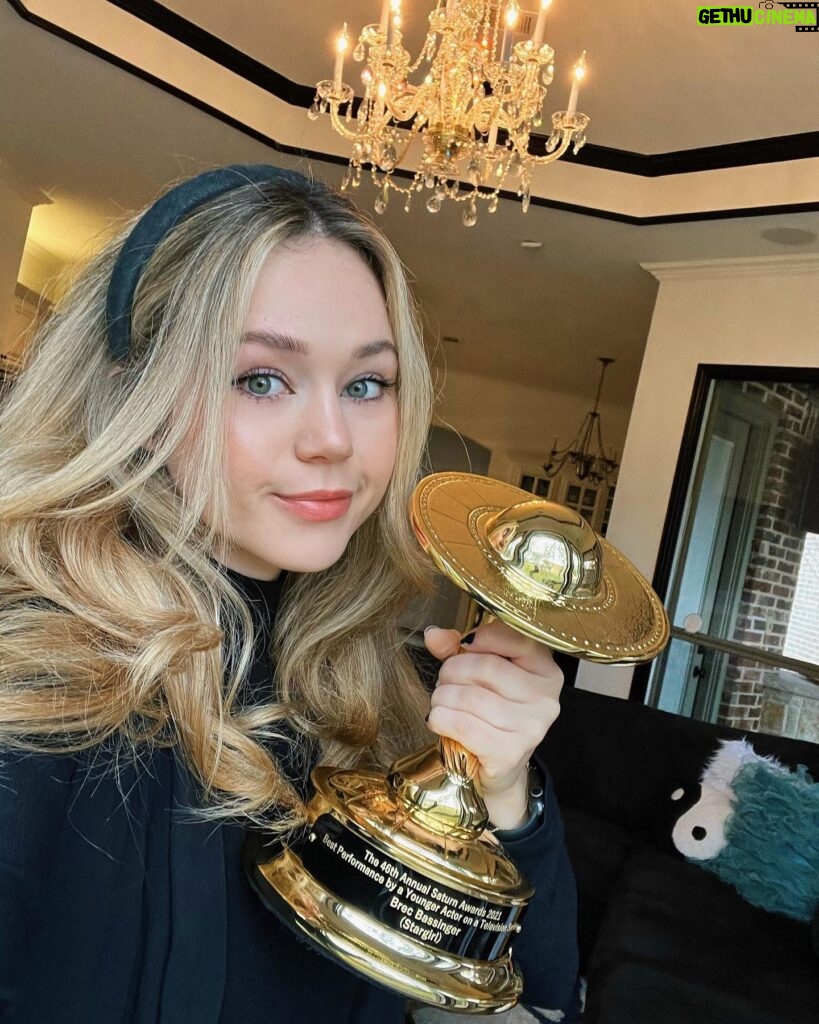 Brec Bassinger Instagram - It was in the midst of my brother and I opening all of the online gifts we had ordered… I open a box… I didn’t recognize what was inside… crap did I open one of his packages… “Beric did you buy me a trophy for Christmas?” I hear a scream in the other room. It’s my mom. ITS YOUR SATURN AWARD. Then I screamed. And now it sits proudly on our mantle. Thank you @saturnawards 💛⭐️ Xo.