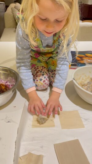 Carrie Bickmore Instagram - Cute little dumpling 🥟 🥰🥹 
Parenting lesson. Addie begged and begged to help Ollie and I make the dumplings, but I assumed cause she is 4 she wouldn’t be able to do it. Was worried she’d make too much of a mess, cover herself in raw seafood, and grizzle that it wasn’t working out. BUT I let her do the last few…and she absolutely nailed it. Her small little fingers were actually perfect for the task and she made better gyoza than I did! Should have never doubted her! #smallbutmighty ❤️