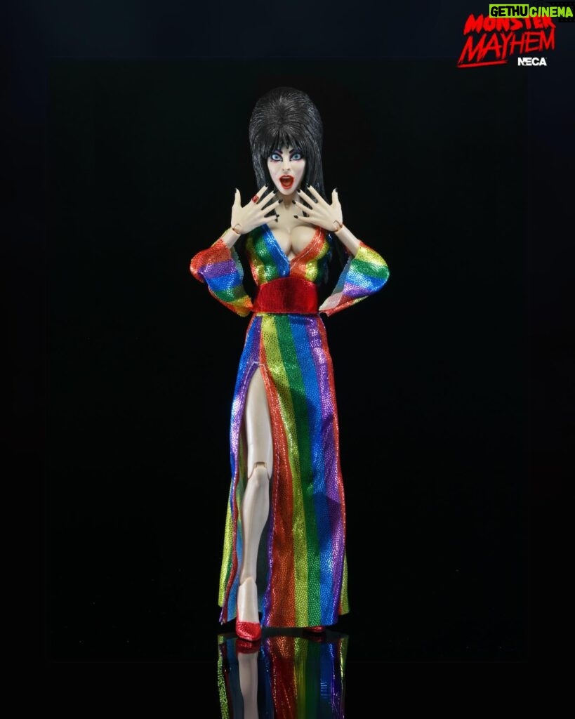 Cassandra Peterson Instagram - ANNOUNCEMENT! 🏳️‍🌈 🖤 ➖ Elvira - Over the Rainbow Elvira 8” Clothed Figure ➖ Celebrate Pride Month with Elvira, Mistress of the Dark! The devilishly delightful Cassandra Peterson has played the part of Elvira for more than 40 years with grace, humor and more than a little camp. NECA is proud to present this “Over the Rainbow” Elvira figure, celebrating the horror and queer icon in a never-before-seen, sparkling rainbow dress for your collection. With an original tailored fabric gown, glittery ruby red heels, and a yellow brick display base, she’s definitely not in Kansas anymore! This fully articulated 8-inch action figure features new faceplate technology with two interchangeable expressions and hands, including brand new ones that allow you to recreate Elvira’s signature pose! She comes with a book accessory of Peterson’s memoir, “Yours Cruelly, Elvira”, and a double-sided flag with 10 stickers to customize and show your unique pride!  ➖ Available now on thenecastore.com, and shipping to your favorite NECA retailer in June! ➖ #Elvira #MistressoftheDark #Pride #OvertheRainbow #CassandraPeterson #NECA #actionfigure