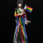 Cassandra Peterson Instagram - ANNOUNCEMENT! 🏳️‍🌈 🖤 ➖ Elvira - Over the Rainbow Elvira 8” Clothed Figure ➖ Celebrate Pride Month with Elvira, Mistress of the Dark! The devilishly delightful Cassandra Peterson has played the part of Elvira for more than 40 years with grace, humor and more than a little camp. NECA is proud to present this “Over the Rainbow” Elvira figure, celebrating the horror and queer icon in a never-before-seen, sparkling rainbow dress for your collection. With an original tailored fabric gown, glittery ruby red heels, and a yellow brick display base, she’s definitely not in Kansas anymore! This fully articulated 8-inch action figure features new faceplate technology with two interchangeable expressions and hands, including brand new ones that allow you to recreate Elvira’s signature pose! She comes with a book accessory of Peterson’s memoir, “Yours Cruelly, Elvira”, and a double-sided flag with 10 stickers to customize and show your unique pride!  ➖ Available now on thenecastore.com, and shipping to your favorite NECA retailer in June! ➖ #Elvira #MistressoftheDark #Pride #OvertheRainbow #CassandraPeterson #NECA #actionfigure