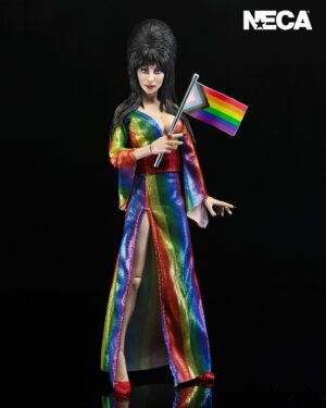 Cassandra Peterson Instagram - ANNOUNCEMENT! 🏳️‍🌈 🖤
➖
Elvira - Over the Rainbow Elvira 8” Clothed Figure 
➖
Celebrate Pride Month with Elvira, Mistress of the Dark! The devilishly delightful Cassandra Peterson has played the part of Elvira for more than 40 years with grace, humor and more than a little camp. NECA is proud to present this “Over the Rainbow” Elvira figure, celebrating the horror and queer icon in a never-before-seen, sparkling rainbow dress for your collection. With an original tailored fabric gown, glittery ruby red heels, and a yellow brick display base, she’s definitely not in Kansas anymore! This fully articulated 8-inch action figure features new faceplate technology with two interchangeable expressions and hands, including brand new ones that allow you to recreate Elvira’s signature pose! She comes with a book accessory of Peterson’s memoir, “Yours Cruelly, Elvira”, and a double-sided flag with 10 stickers to customize and show your unique pride! 
➖
Available now on thenecastore.com, and shipping to your favorite NECA retailer in June!
➖
#Elvira #MistressoftheDark #Pride #OvertheRainbow #CassandraPeterson #NECA  #actionfigure