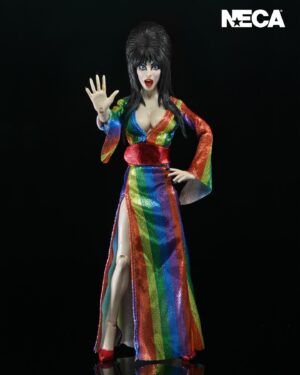 Cassandra Peterson Instagram - ANNOUNCEMENT! 🏳️‍🌈 🖤
➖
Elvira - Over the Rainbow Elvira 8” Clothed Figure 
➖
Celebrate Pride Month with Elvira, Mistress of the Dark! The devilishly delightful Cassandra Peterson has played the part of Elvira for more than 40 years with grace, humor and more than a little camp. NECA is proud to present this “Over the Rainbow” Elvira figure, celebrating the horror and queer icon in a never-before-seen, sparkling rainbow dress for your collection. With an original tailored fabric gown, glittery ruby red heels, and a yellow brick display base, she’s definitely not in Kansas anymore! This fully articulated 8-inch action figure features new faceplate technology with two interchangeable expressions and hands, including brand new ones that allow you to recreate Elvira’s signature pose! She comes with a book accessory of Peterson’s memoir, “Yours Cruelly, Elvira”, and a double-sided flag with 10 stickers to customize and show your unique pride! 
➖
Available now on thenecastore.com, and shipping to your favorite NECA retailer in June!
➖
#Elvira #MistressoftheDark #Pride #OvertheRainbow #CassandraPeterson #NECA  #actionfigure