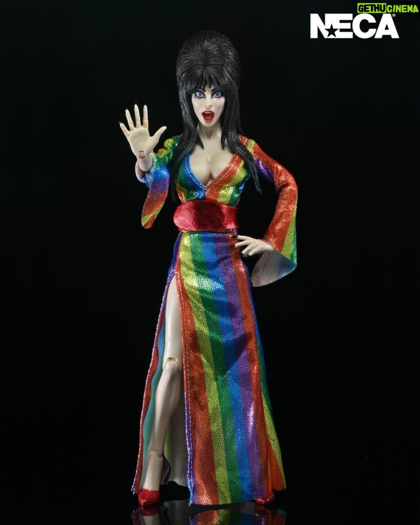 Cassandra Peterson Instagram - ANNOUNCEMENT! 🏳️‍🌈 🖤 ➖ Elvira - Over the Rainbow Elvira 8” Clothed Figure ➖ Celebrate Pride Month with Elvira, Mistress of the Dark! The devilishly delightful Cassandra Peterson has played the part of Elvira for more than 40 years with grace, humor and more than a little camp. NECA is proud to present this “Over the Rainbow” Elvira figure, celebrating the horror and queer icon in a never-before-seen, sparkling rainbow dress for your collection. With an original tailored fabric gown, glittery ruby red heels, and a yellow brick display base, she’s definitely not in Kansas anymore! This fully articulated 8-inch action figure features new faceplate technology with two interchangeable expressions and hands, including brand new ones that allow you to recreate Elvira’s signature pose! She comes with a book accessory of Peterson’s memoir, “Yours Cruelly, Elvira”, and a double-sided flag with 10 stickers to customize and show your unique pride!  ➖ Available now on thenecastore.com, and shipping to your favorite NECA retailer in June! ➖ #Elvira #MistressoftheDark #Pride #OvertheRainbow #CassandraPeterson #NECA #actionfigure
