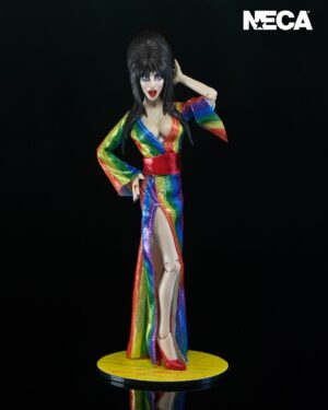 Cassandra Peterson Instagram - ANNOUNCEMENT! 🏳️‍🌈 🖤
➖
Elvira - Over the Rainbow Elvira 8” Clothed Figure 
➖
Celebrate Pride Month with Elvira, Mistress of the Dark! The devilishly delightful Cassandra Peterson has played the part of Elvira for more than 40 years with grace, humor and more than a little camp. NECA is proud to present this “Over the Rainbow” Elvira figure, celebrating the horror and queer icon in a never-before-seen, sparkling rainbow dress for your collection. With an original tailored fabric gown, glittery ruby red heels, and a yellow brick display base, she’s definitely not in Kansas anymore! This fully articulated 8-inch action figure features new faceplate technology with two interchangeable expressions and hands, including brand new ones that allow you to recreate Elvira’s signature pose! She comes with a book accessory of Peterson’s memoir, “Yours Cruelly, Elvira”, and a double-sided flag with 10 stickers to customize and show your unique pride! 
➖
Available now on thenecastore.com, and shipping to your favorite NECA retailer in June!
➖
#Elvira #MistressoftheDark #Pride #OvertheRainbow #CassandraPeterson #NECA  #actionfigure