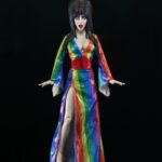 Cassandra Peterson Instagram - ANNOUNCEMENT! 🏳️‍🌈 🖤 ➖ Elvira - Over the Rainbow Elvira 8” Clothed Figure ➖ Celebrate Pride Month with Elvira, Mistress of the Dark! The devilishly delightful Cassandra Peterson has played the part of Elvira for more than 40 years with grace, humor and more than a little camp. NECA is proud to present this “Over the Rainbow” Elvira figure, celebrating the horror and queer icon in a never-before-seen, sparkling rainbow dress for your collection. With an original tailored fabric gown, glittery ruby red heels, and a yellow brick display base, she’s definitely not in Kansas anymore! This fully articulated 8-inch action figure features new faceplate technology with two interchangeable expressions and hands, including brand new ones that allow you to recreate Elvira’s signature pose! She comes with a book accessory of Peterson’s memoir, “Yours Cruelly, Elvira”, and a double-sided flag with 10 stickers to customize and show your unique pride!  ➖ Available now on thenecastore.com, and shipping to your favorite NECA retailer in June! ➖ #Elvira #MistressoftheDark #Pride #OvertheRainbow #CassandraPeterson #NECA #actionfigure