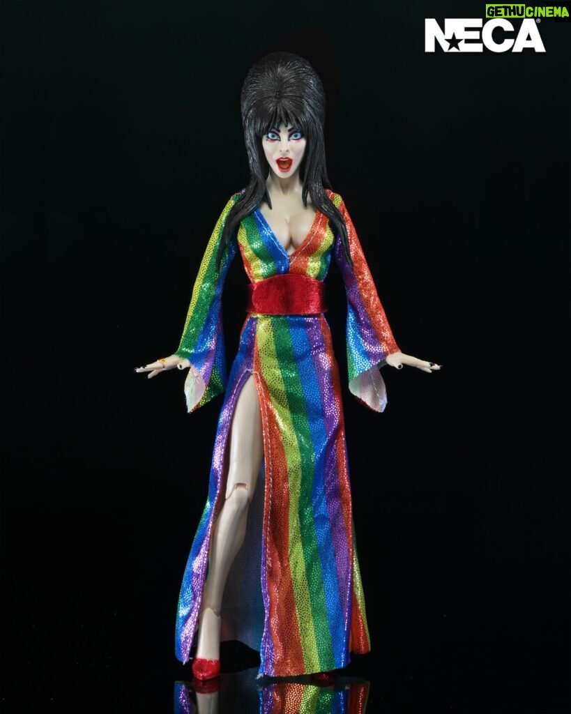 Cassandra Peterson Instagram - ANNOUNCEMENT! 🏳️‍🌈 🖤 ➖ Elvira - Over the Rainbow Elvira 8” Clothed Figure ➖ Celebrate Pride Month with Elvira, Mistress of the Dark! The devilishly delightful Cassandra Peterson has played the part of Elvira for more than 40 years with grace, humor and more than a little camp. NECA is proud to present this “Over the Rainbow” Elvira figure, celebrating the horror and queer icon in a never-before-seen, sparkling rainbow dress for your collection. With an original tailored fabric gown, glittery ruby red heels, and a yellow brick display base, she’s definitely not in Kansas anymore! This fully articulated 8-inch action figure features new faceplate technology with two interchangeable expressions and hands, including brand new ones that allow you to recreate Elvira’s signature pose! She comes with a book accessory of Peterson’s memoir, “Yours Cruelly, Elvira”, and a double-sided flag with 10 stickers to customize and show your unique pride!  ➖ Available now on thenecastore.com, and shipping to your favorite NECA retailer in June! ➖ #Elvira #MistressoftheDark #Pride #OvertheRainbow #CassandraPeterson #NECA #actionfigure