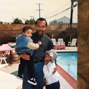 Chelsea Tavares Instagram - It’s been a month since My dad has passed. we were all nervous about posting it, because it makes it a bit more real , now that it’s public. A Post will never hold enough weight to let people know how much you impacted us and others around us. From our family, to friends, to neighbors, to the people that worked at your favorite donut shop. you were the person that loved and people called on. You were the Father to people that didn’t have a father . when our friends and ex’s fly out of state just to see you one more time before you go, you know you’re the shit. No matter what happened in life, you were always there. Always on time to pick us up from school, or the airport. You were the cook of the house. we were the house, where you knew my dad was gonna grill and make some bomb burgers or steak while mommy drank her white wine and cleaned.  you quietly sized up all of me and my sisters dates.. You would leave Hershey chocolate bars on our pillows in the morning every valentine’s day. Even when mommy was mad, you grabbed her , kissed her, and would squeeze her butt until she laughed. when i think of GOOD CLASSIC music. like that bobby Caldwell , Phil collins, The Beatles, Debarge music. I think of you. The Police was our favorite band. we would play it driving down to San diego. we shared our love for vintage cars and black and white movies.  you made me Look up all of the black actresses & singers that i didn’t know about from the 40’s and 50’s.  Koden keeps asking for “pop pop”. it’s really hard to answer him. you said watching a movie and having a bowl of Vanilla ice cream with him , was you and koden’s “thing”. so I will continue to remind him of that. he had a bowl the other day ♥️ Currently wearing your T shirt and the bracelet you got me for my 30th.  It’s so surreal. I wish I could hug you, i wish you would call me saying “i don’t want nothing, just want to tell you I love you.” There is always gonna be a hole in my heart. I wish you could have walked us down the aisle, but i believe we have too much character and personality for the spirit to just not be here any more. i can literally feel you around. we just miss you. that’s all. ♥️your “Chelsea Baby”