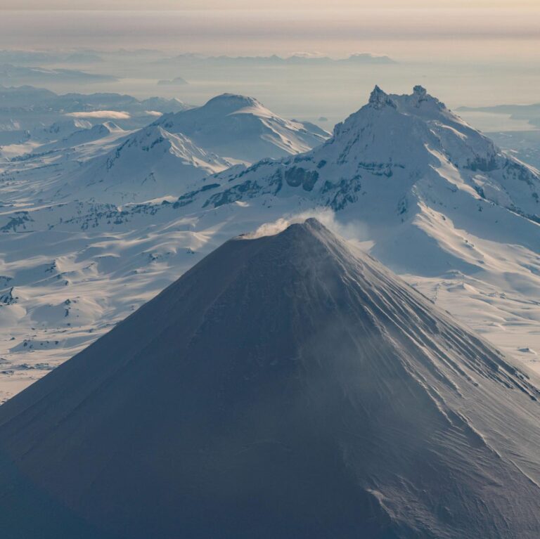 Chris Burkard Instagram - Stretching between the shores of Alaska and Russia, this chain of 14 volcanoes and 55 smaller land masses make up what is known as the Aleutian Islands… one of the most remote and difficult landscapes I’ve photographed - due to the harsh storms the frequent the Bering sea that often shrouds them in thick clouds & fog. In the past, I had set out to these islands with the goal of surfing in mind.. but in 2018, I received a grant from Conservation International to document the Alaska Maritime Wildlife Refuge - focusing more on showing the scope of the landscape and it’s largely undisturbed beauty. We caught a window in the weather - so I grabbed my camera & jumped in a small plane… resulting in some of the most unforgettable aerial views of my career.