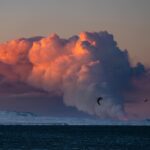 Chris Burkard Instagram - I jumped out of bed this morning for an early ski touring lap to catch sunrise... but much to my surprise I saw a warm glow radiating from the Reykjanes Peninsula and realized that a new volcano just erupted. I texted my assistant @joelbarger_ from the top of the mountain - who grabbed our long lens and nailed the shot just looking over the bay not far from our new studio. It’s moments like this in Iceland that continue to amaze me... a juxtaposition of normal life and sometimes devastating elements, locals continuing their day like any other Thursday but a beautiful fiery chaos erupts less than 45 minutes away.