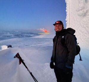 Chris Burkard Instagram - I jumped out of bed this morning for an early ski touring lap to catch sunrise... but much to my surprise I saw a warm glow radiating from the Reykjanes Peninsula and realized that a new volcano just erupted.  I texted my assistant @joelbarger_ from the top of the mountain -  who grabbed our long lens and nailed the shot just looking over the bay not far from our new studio. It’s moments like this in Iceland that continue to amaze me... a juxtaposition of normal life and sometimes devastating elements, locals continuing their day like any other Thursday but a beautiful fiery chaos erupts less than 45 minutes away.