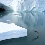 Chris Burkard Instagram - Cold dipping before it was cool… I have a print up of this moment in my Iceland gallery… lot of people asked if it was fake or photoshopped so I thought I’d share the iPhone clip so everyone could see the brave soul testing out the waters off of Greenland in real time…