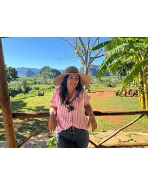 Chrissie Fit Instagram - Who would’ve pegged me as a guajira? Los paisajes de Cuba son una maravilla. The Cuban countryside is unreal. I recommend you go there and buy tobacco directly from the farmers. They are forced to give 90% of their crops to the government and only have 10% to sell themselves. It’s more authentic this way and you’re helping the farmer, who takes so much pride in growing their tobacco, fruits, veggies, and coffee. Btw, I did not know how to smoke a cigar. At the risk of losing my Cuban card, I will post in my stories 😅

#Cuba #Vinales #CuevaDelIndio #palenquedeloscimarrones #cubancountryside #ReturnToMyRoots #CubanHeritage #Cuban #Guajiro #Guajira