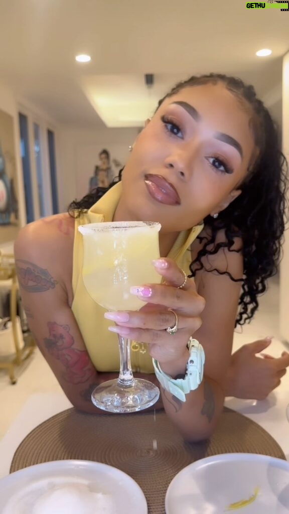 Coi Leray Instagram - let’s make a classic “LEMON DROP” 😍😜 In honor of my new single Lemon Cars dropping this week 5/10 HAPPY Cinco De Mayo 🥳🥂💚🤍❤️ Ingredient’s: Fresh lemons 🍋 Simple syrup vodka or Tequila (I used Casamigos blanco) Ice Sugar Shot glass to measure 📐