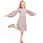 Danielle Busby Instagram - Just gotta love my little model PK 🥰 She literally is talented in everything she does…from dancing, to sports, to even modeling @graesonbee NEW attire!! (Shoes available now but feature outfits Launching online tomorrow, Monday😉) PK has come out of her shell so much and I l.o.v.e seeing that beautiful strong smile of hers! Daddy has his hands full, no literally 🤣 #sixbeautifuldaughters #smile #itsabuzzworld #outdaughtered #graesonbeeboutique #shopsmall #onlineshopping