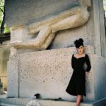 Dita Von Teese Instagram - Flashback to the mid-90s in Paris at #perelachaise with the monument of #oscarwilde before it was protected by glass. I personally did not add a lipstick print, as I had just visited #victornoir 🖤 More of these photos, plus video are up for subscribers, link in bio. 📷 @christophe_mourthe
