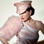 Dita Von Teese Instagram - English translation of  'FEMME DE TÊTE': Assertive woman. Soft but unyielding, this satin officers cap was inspired from @ditavonteese ‘s fetish modeling days, with a candy colored twist. (Obviously available in Black as well, we haven’t gone completely mad.) @ditavonteese by @travis_shinn Dresses: @maguydechadirac @lenahoschek @jennypackham Jewlery: @sillamjewelry #hoodxdita #travisshinn #ditavonteese #hoodlondon #millinery #vintagestyle #glamour