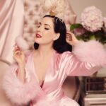 Dita Von Teese Instagram - ‘POULE DE LUXE’ This golden bird is available with or without feather plumes. These luxurious showgirl add-ons are removable and available in several different colors. Talk about a bird of a different feather… 🦢 @ditavonteese @dedwardsphoto Dressing gown @catherinedlish #ditaxhood #hoodlondon #ditavonteese #luxuryfashion #showgirl #burlesque