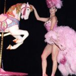 Dita Von Teese Instagram - The Carousel Horse ✨🎠✨ When @catherinedlish and I first debuted this act in 2001, as the new wave of burlesque was underway, it blew expectations among audiences and fellow entertainers. The top hat. The costume. The #carousel horse complete with shiny brass pole. Everything blindingly and colorfully twinkled with @swarovski ✨ Catherine’s costume was the most over the top she had done at the time. In my 2002 #Playboy cover story, I posed in my full “Carousel” act regalia, from plume to #pointe shoes, perched atop the twee horse. Alas, that #bedazzled beast went missing a few years later and we had to remake it. For Dita Las Vegas, three of the four jeweled horses now in my “stable” appear, side straddled by Von Teese Dancers in Jubilee archival costumes. 🌟Dita Las Vegas has added even more shows! 🌟 March 27, 28, 29, 30 April 3, 4, 5, 6 April 10, 11, 12, 13 April 17, 18, 19, 20 April 24, 25, 26, 27 May 16, 17, 18 May 21, 23, 24, 25 May 29, 30, 31, June 1 June 5, 6, 7, 8 June 12, 13, 14, 15 Ticketmaster.com/ditavegas