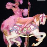 Dita Von Teese Instagram - The Carousel Horse ✨🎠✨ When @catherinedlish and I first debuted this act in 2001, as the new wave of burlesque was underway, it blew expectations among audiences and fellow entertainers. The top hat. The costume. The #carousel horse complete with shiny brass pole. Everything blindingly and colorfully twinkled with @swarovski ✨ Catherine’s costume was the most over the top she had done at the time. In my 2002 #Playboy cover story, I posed in my full “Carousel” act regalia, from plume to #pointe shoes, perched atop the twee horse. Alas, that #bedazzled beast went missing a few years later and we had to remake it. For Dita Las Vegas, three of the four jeweled horses now in my “stable” appear, side straddled by Von Teese Dancers in Jubilee archival costumes. 🌟Dita Las Vegas has added even more shows! 🌟 March 27, 28, 29, 30 April 3, 4, 5, 6 April 10, 11, 12, 13 April 17, 18, 19, 20 April 24, 25, 26, 27 May 16, 17, 18 May 21, 23, 24, 25 May 29, 30, 31, June 1 June 5, 6, 7, 8 June 12, 13, 14, 15 Ticketmaster.com/ditavegas