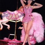 Dita Von Teese Instagram - The Carousel Horse ✨🎠✨ When @catherinedlish and I first debuted this act in 2001, as the new wave of burlesque was underway, it blew expectations among audiences and fellow entertainers. The top hat. The costume. The #carousel horse complete with shiny brass pole. Everything blindingly and colorfully twinkled with @swarovski ✨ Catherine’s costume was the most over the top she had done at the time. In my 2002 #Playboy cover story, I posed in my full “Carousel” act regalia, from plume to #pointe shoes, perched atop the twee horse. Alas, that #bedazzled beast went missing a few years later and we had to remake it. For Dita Las Vegas, three of the four jeweled horses now in my “stable” appear, side straddled by Von Teese Dancers in Jubilee archival costumes. 🌟Dita Las Vegas has added even more shows! 🌟 March 27, 28, 29, 30 April 3, 4, 5, 6 April 10, 11, 12, 13 April 17, 18, 19, 20 April 24, 25, 26, 27 May 16, 17, 18 May 21, 23, 24, 25 May 29, 30, 31, June 1 June 5, 6, 7, 8 June 12, 13, 14, 15 Ticketmaster.com/ditavegas