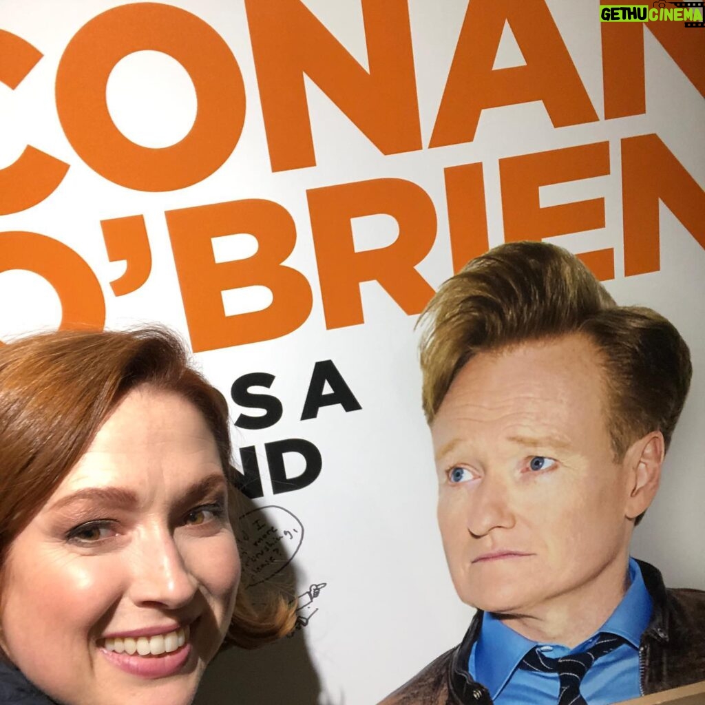 Ellie Kemper Instagram - Here I am giddily posing with a poster of my favorite podcast in the world, hosted by the funniest man in the world, who just so happens to have been my first boss in the world (not counting temp bosses)!!! My episode of “Conan O’Brien Needs A Friend” is out now on @earwolf or wherever you get your podcasts. Thank you @teamcoco 🙌🙌🙌