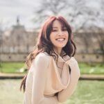 Grace Chan Instagram - The girl in a park in Paris. ⛲️ Before you think how uninspired this caption title is, here me out: The first time I went to Paris was when I was 10 or 11 with my family. It was one of those tour-guided trips —7 countries in 7 days around Europe— and guess what? I LOVED IT. I remember eating escargots for the first time I remember making up songs on the bus with my sister I also remember running through the park, surrounded by French colonial buildings…🤍🩷 And now so many years later, I’m back, but still that girl at heart. What’s your favorite Parisian memory?