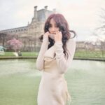 Grace Chan Instagram - The girl in a park in Paris. ⛲️ Before you think how uninspired this caption title is, here me out: The first time I went to Paris was when I was 10 or 11 with my family. It was one of those tour-guided trips —7 countries in 7 days around Europe— and guess what? I LOVED IT. I remember eating escargots for the first time I remember making up songs on the bus with my sister I also remember running through the park, surrounded by French colonial buildings…🤍🩷 And now so many years later, I’m back, but still that girl at heart. What’s your favorite Parisian memory?